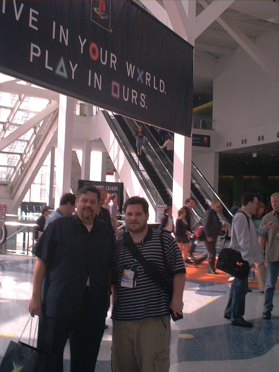Lars and Shawn in front of PlayStation's iconic "Live in your world, play in ours" banner.