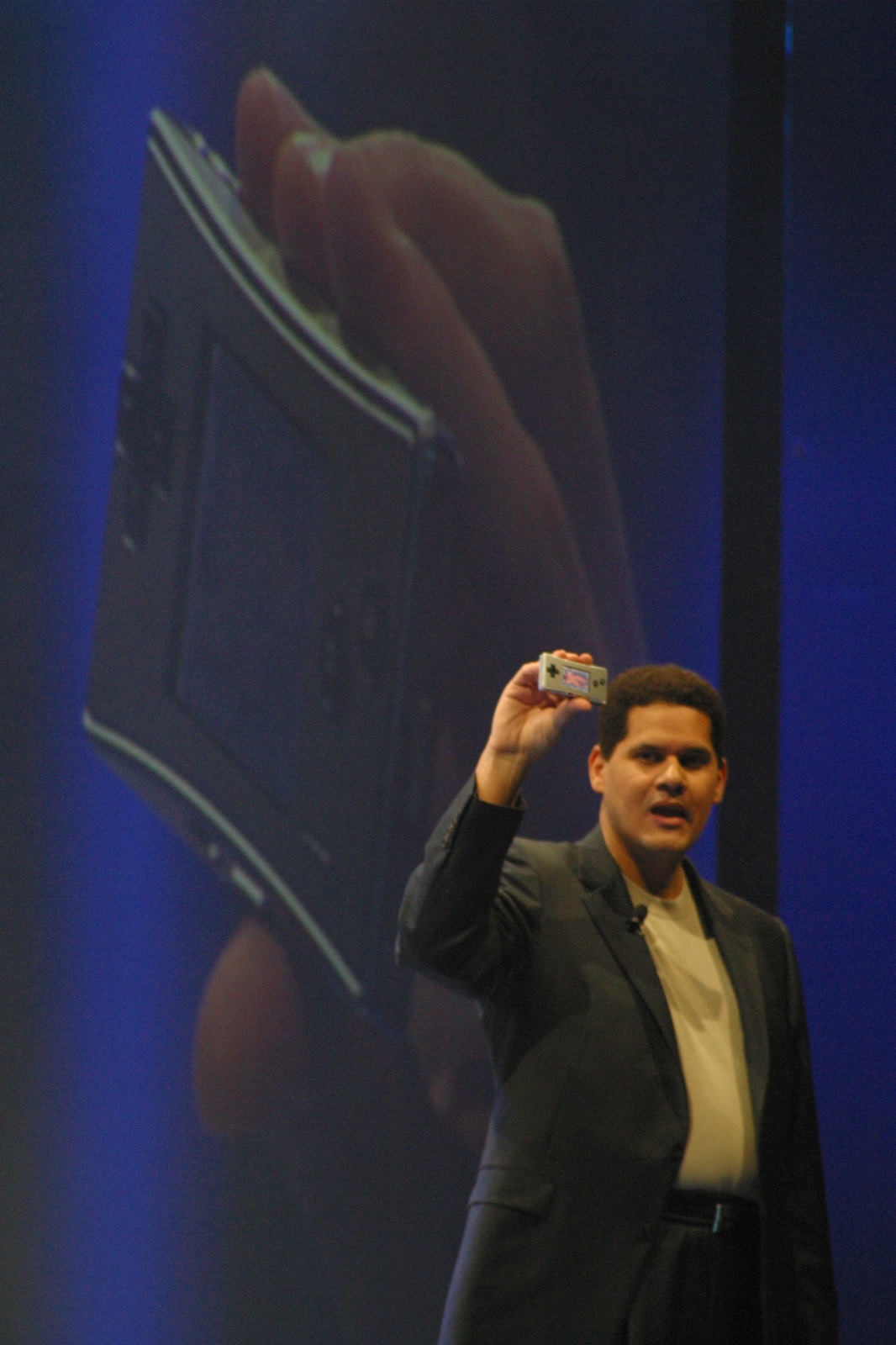 Reggie Fils-Aime holds up a Game Boy Micro at the Nintendo press conference — "My body is ready" energy before that was even a thing.