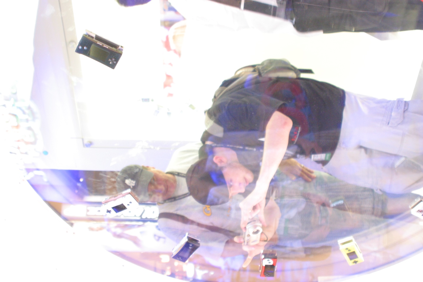 A reflective display case with Game Boy Micro units and other handhelds — the future of portable gaming.