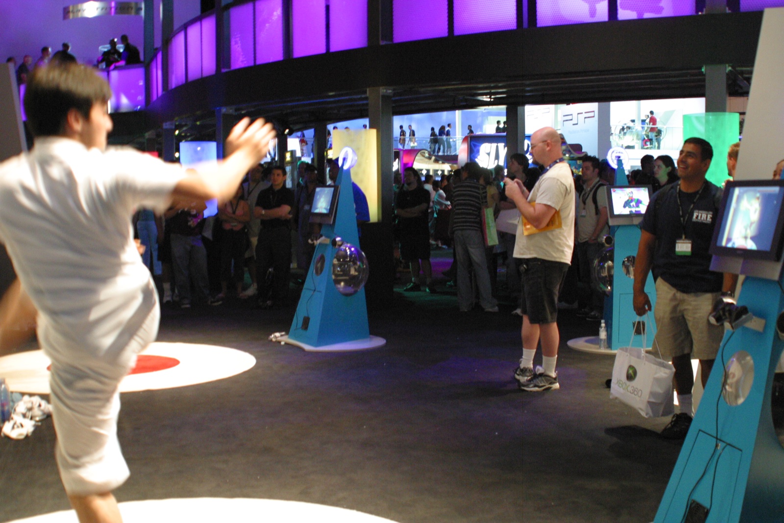 The Sony PSP lounge area — attendees trying out the handheld under purple lighting.