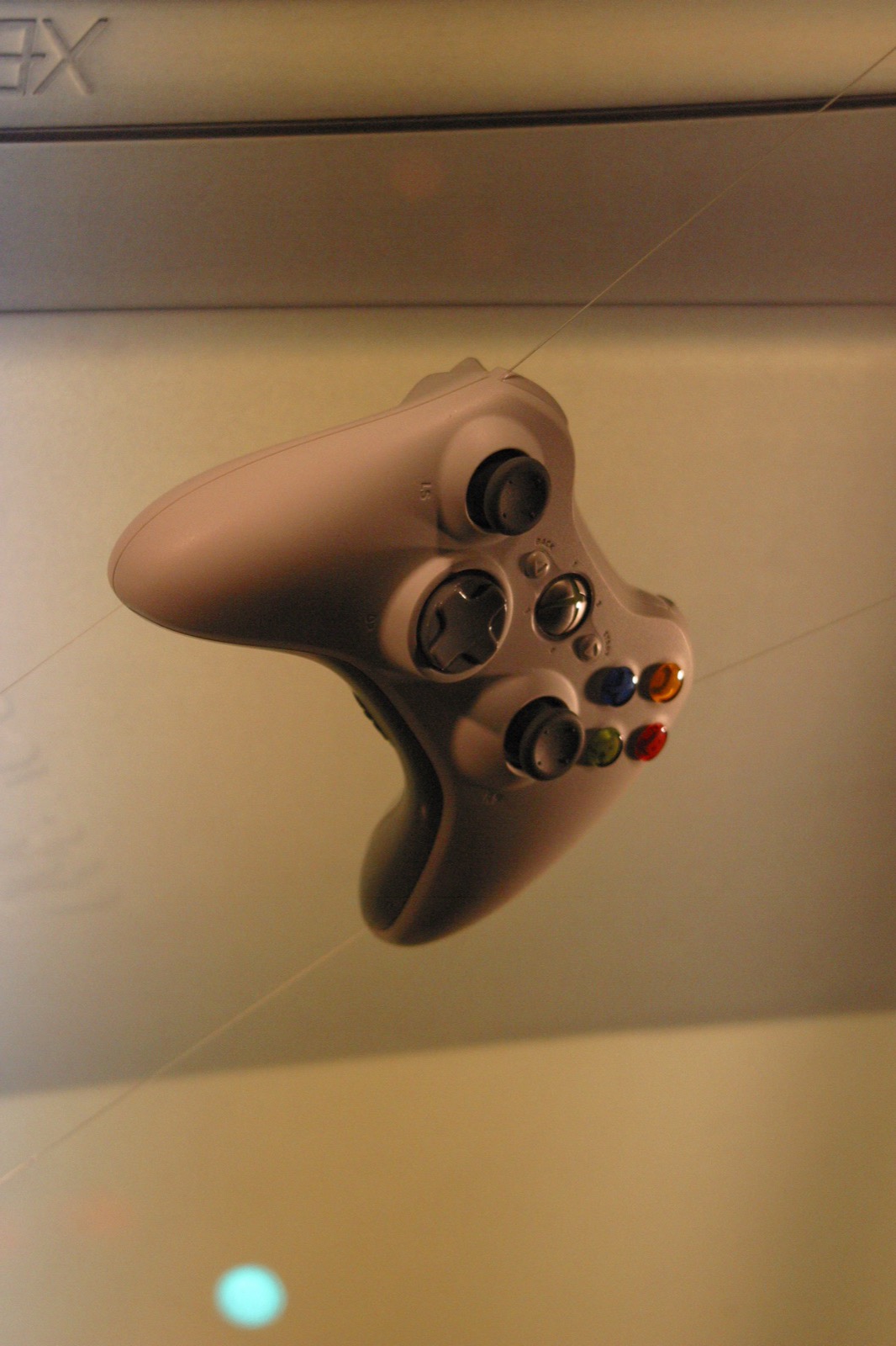 The Xbox 360 wireless controller in a display case — sleek, white, and brand new to the world.