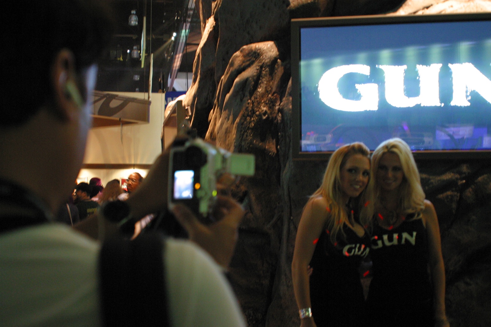 Attendees snapping photos at the GUN booth — Neversoft's Wild West shooter had a rustic, rocky display.